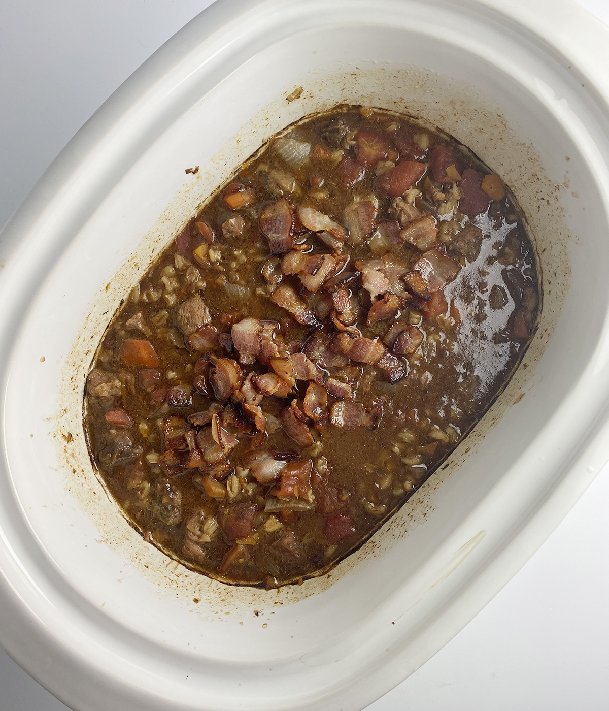 Cooked beef bacon soup in a slow cooker.