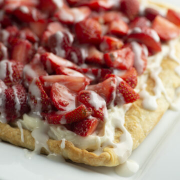 Strawberry slab pie on a white platter.