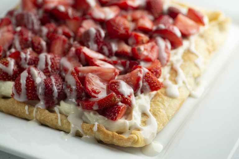 Strawberry slab pie on a white platter.