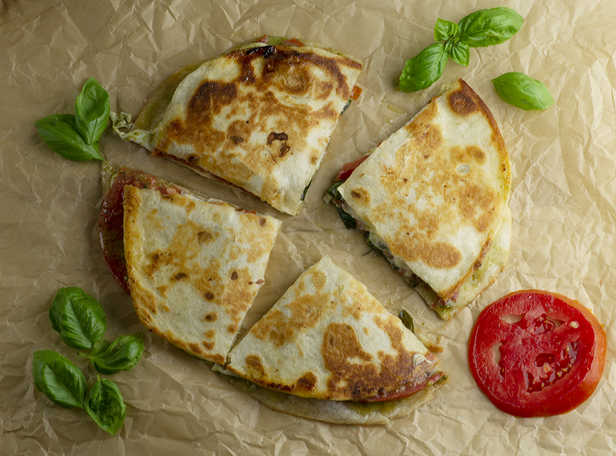 Caprese Quesadilla with basil and tomato.