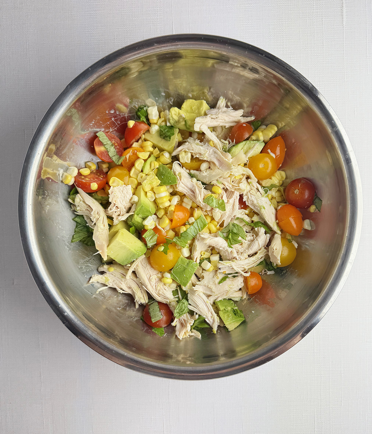 Summer chicken salad in a mixing bowl.