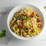 Tortellini with vegetables in a bowl.