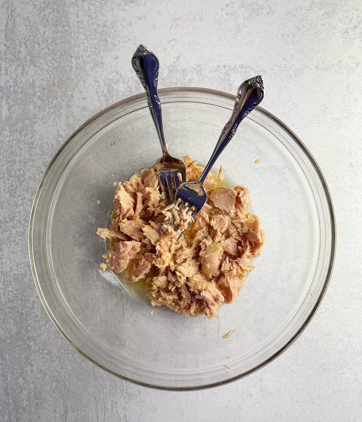 Flaked tuna in a mixing bowl.