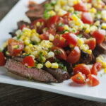 Spice Rubbed Steak with Corn Tomato Salsa on a plate.