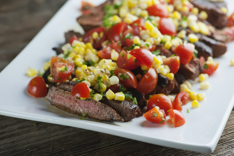 Spice Rubbed Steak with Corn Tomato Salsa on a plate.