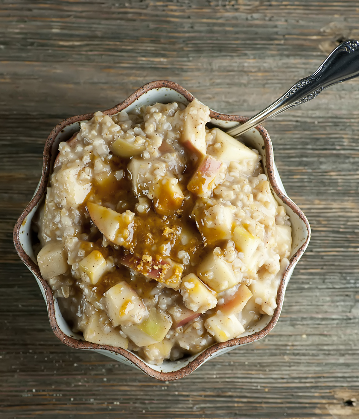 Bowl of apple pie oatmeal with a spoon.