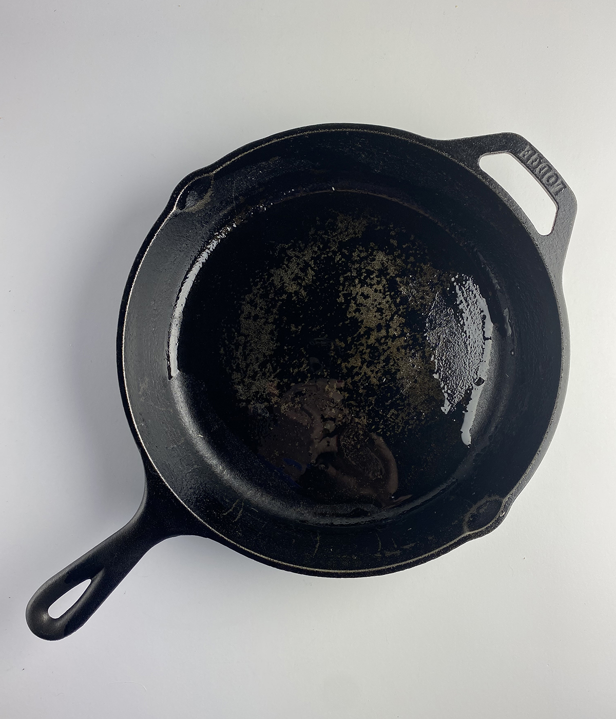 Cast iron skillet coated with oil.