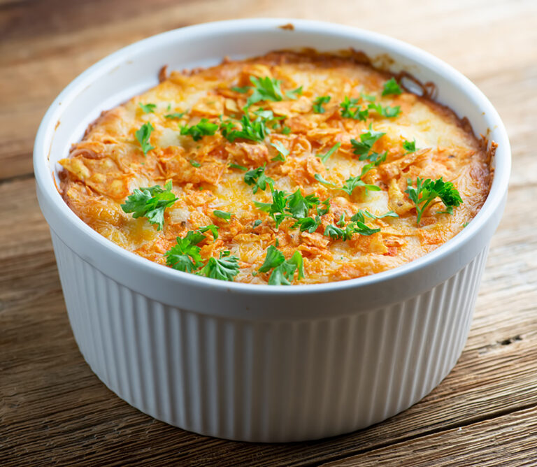 Dorito Chicken Casserole on a wooden counter.