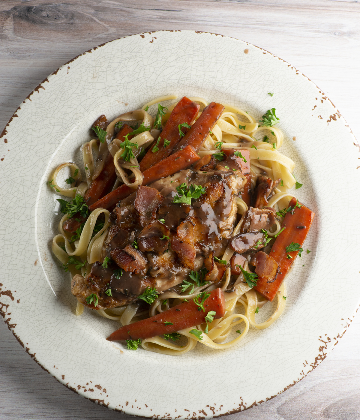 Easy coq au vin with pasta on a plate.