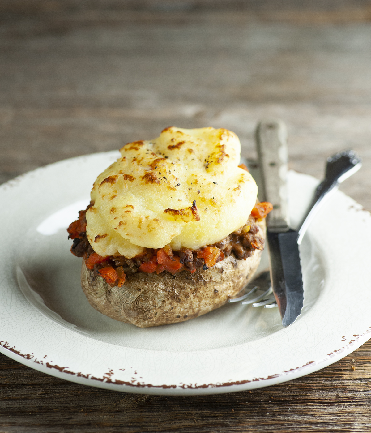 Finished shepherd's pie baked potato on a plate.