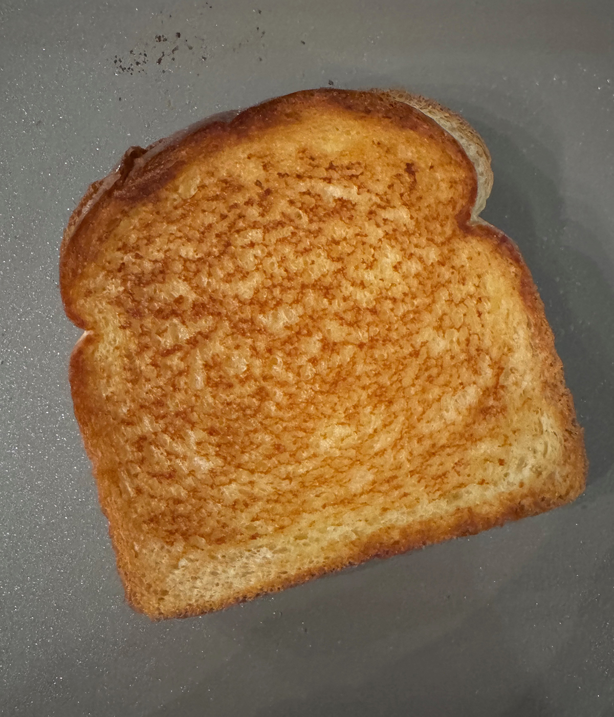 Grilled cheese sandwich on a griddle.