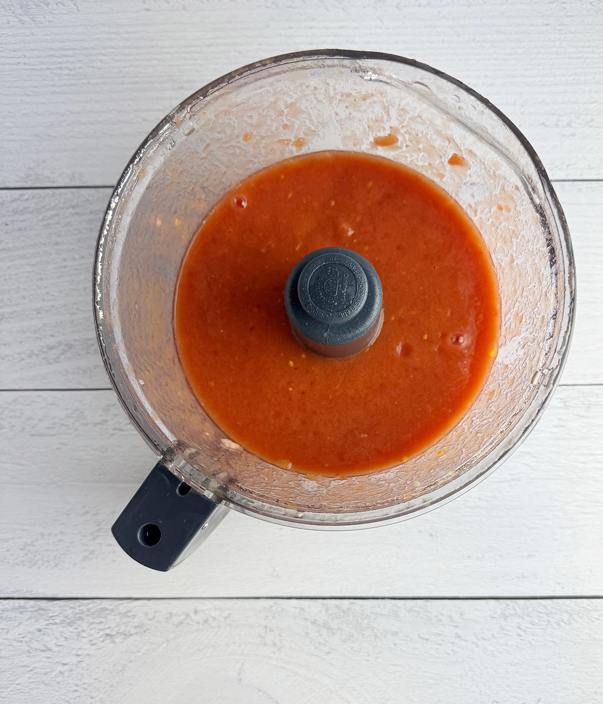 Pureed tomatoes in a food processor.