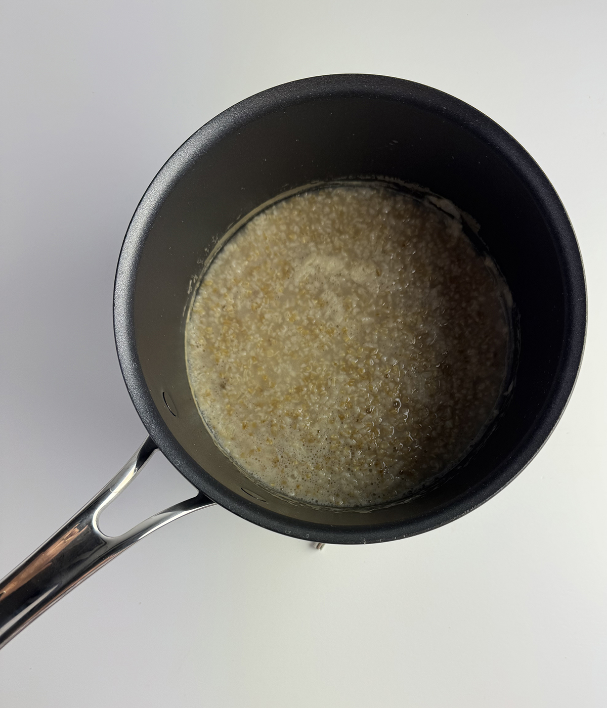 Steel cut oats cooking in a pot.