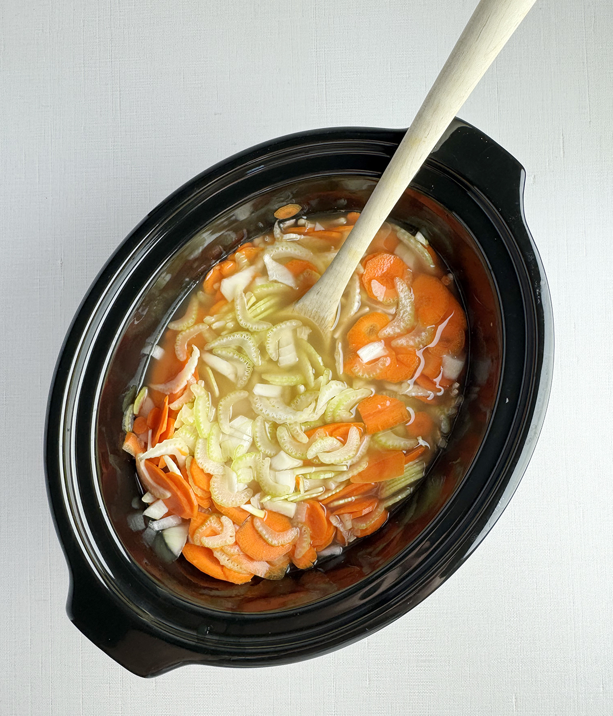 Chicken noodle soup ingredients in the slow cooker.