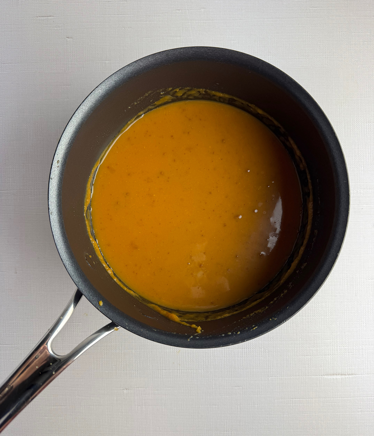 Pumpkin soup cooking in a pot.