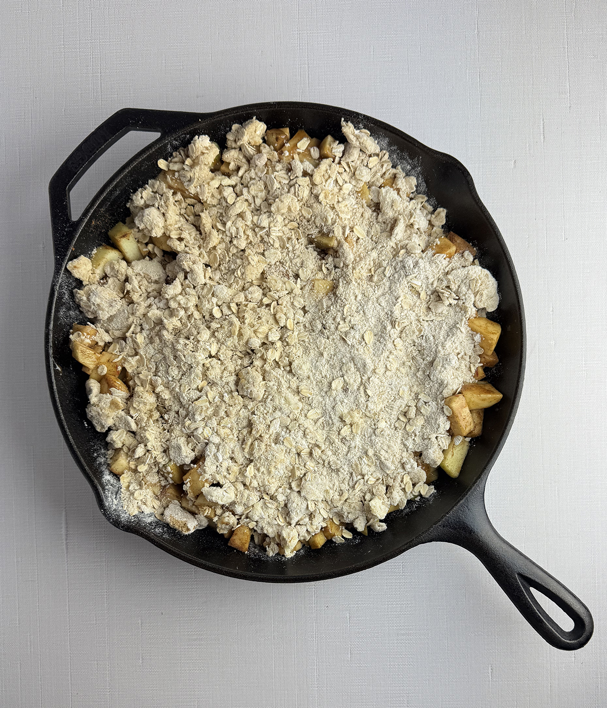 Skillet apple crisp ready for the oven.
