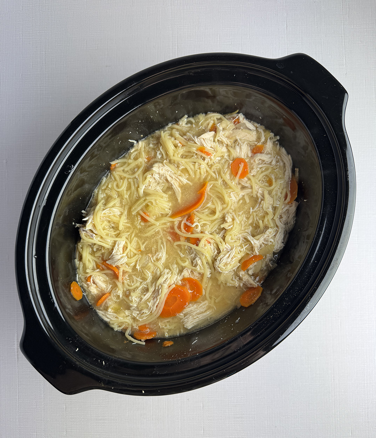 Slow cooker chicken noodle soup in the slow cooker.