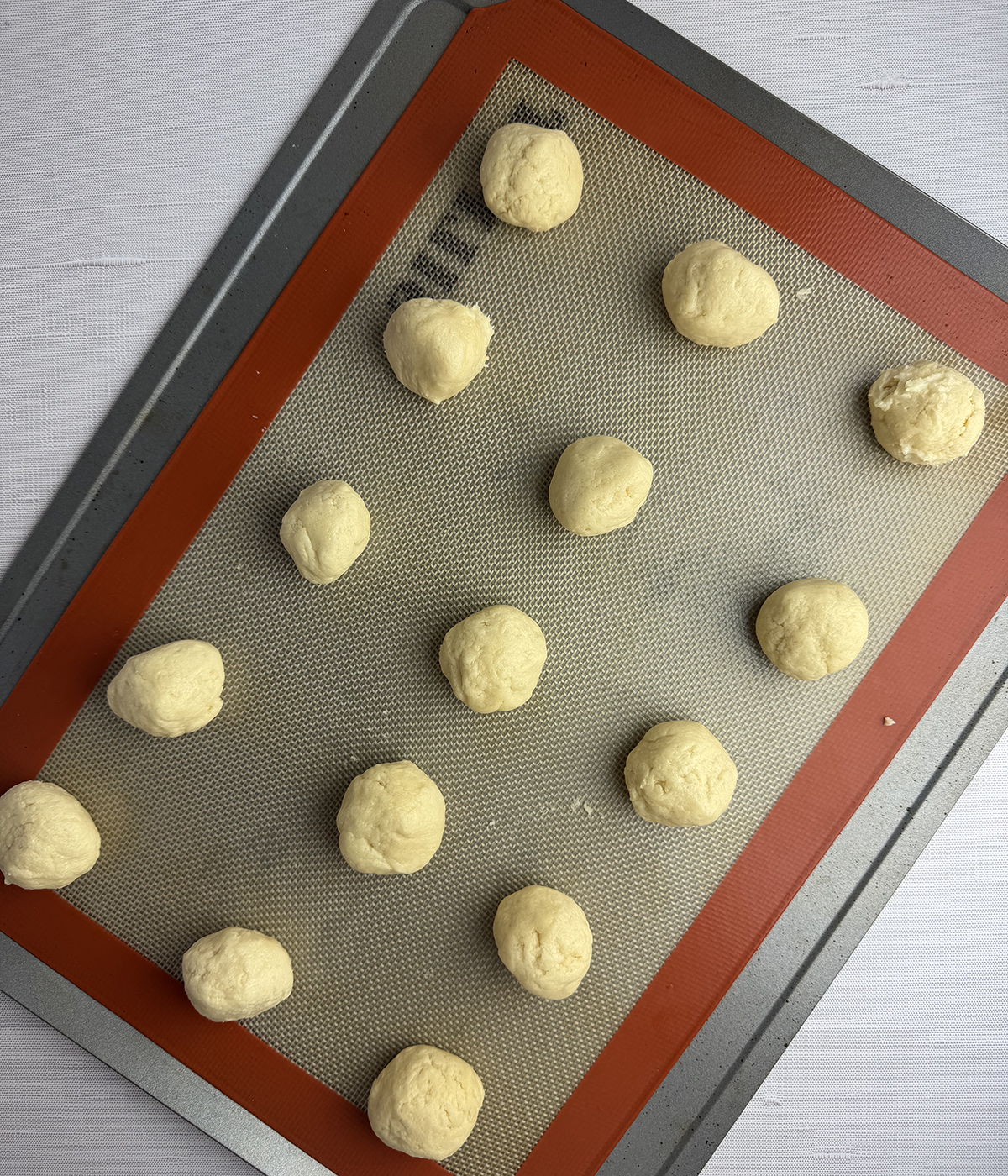 Snickerdoodle cookie dough on a cookie sheet.