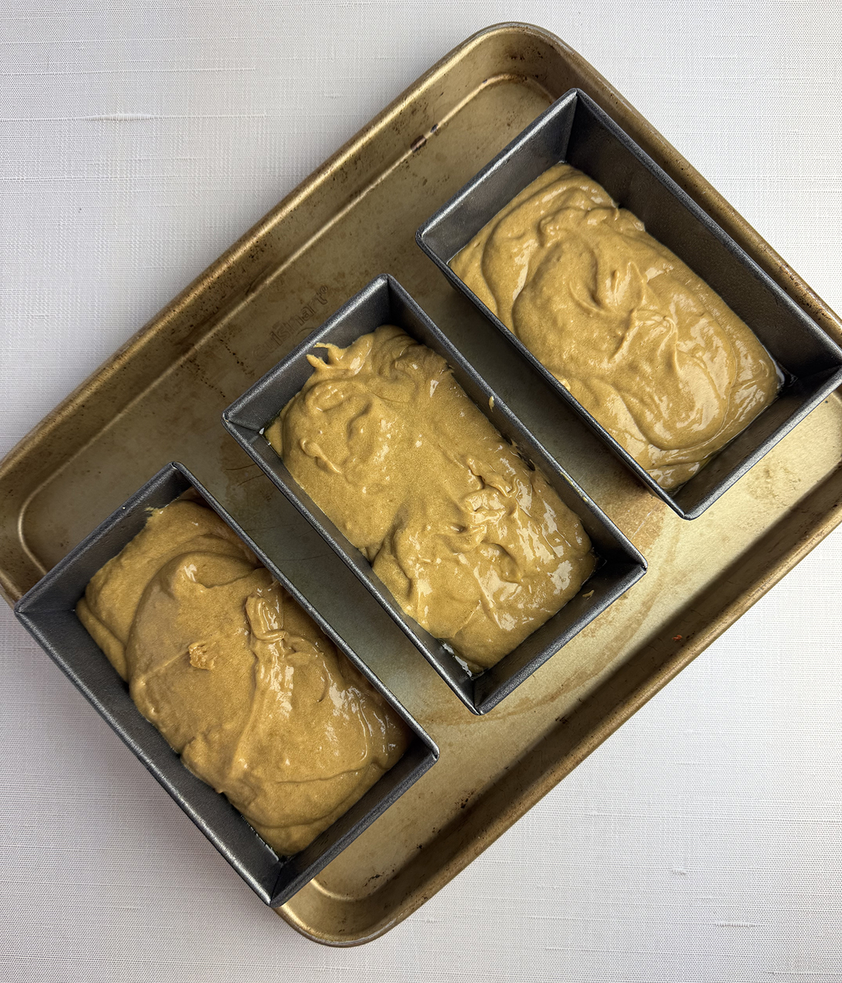 Banana gingerbread batter in loaf pans.