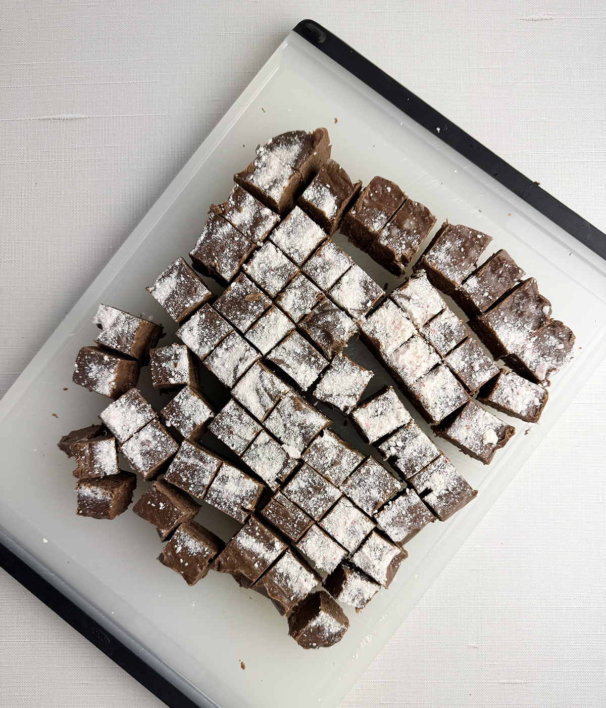 Cut up fudge on a paper plate.