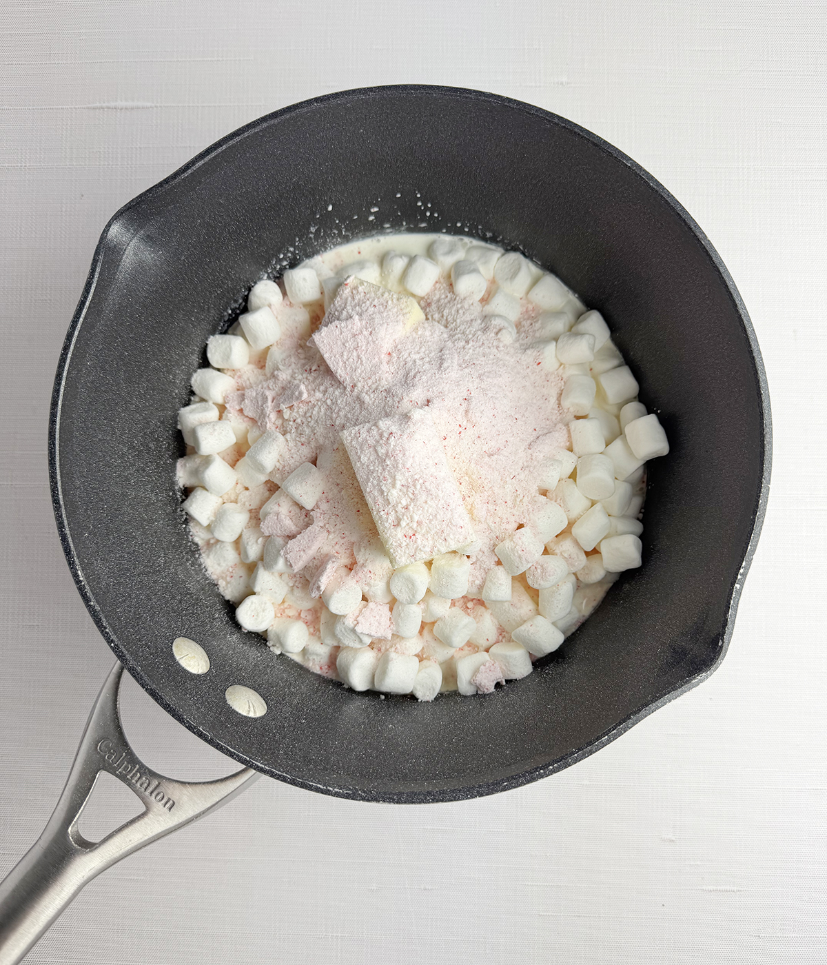 Marshmallows butter and peppermint in a mixing bowl.