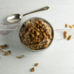 Baklava Oatmeal in a bowl with walnuts.