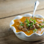 Bowl of tomato meatball soup.