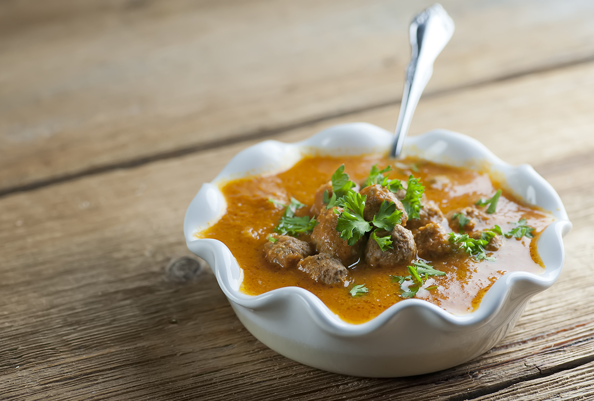 Bowl of tomato meatball soup.