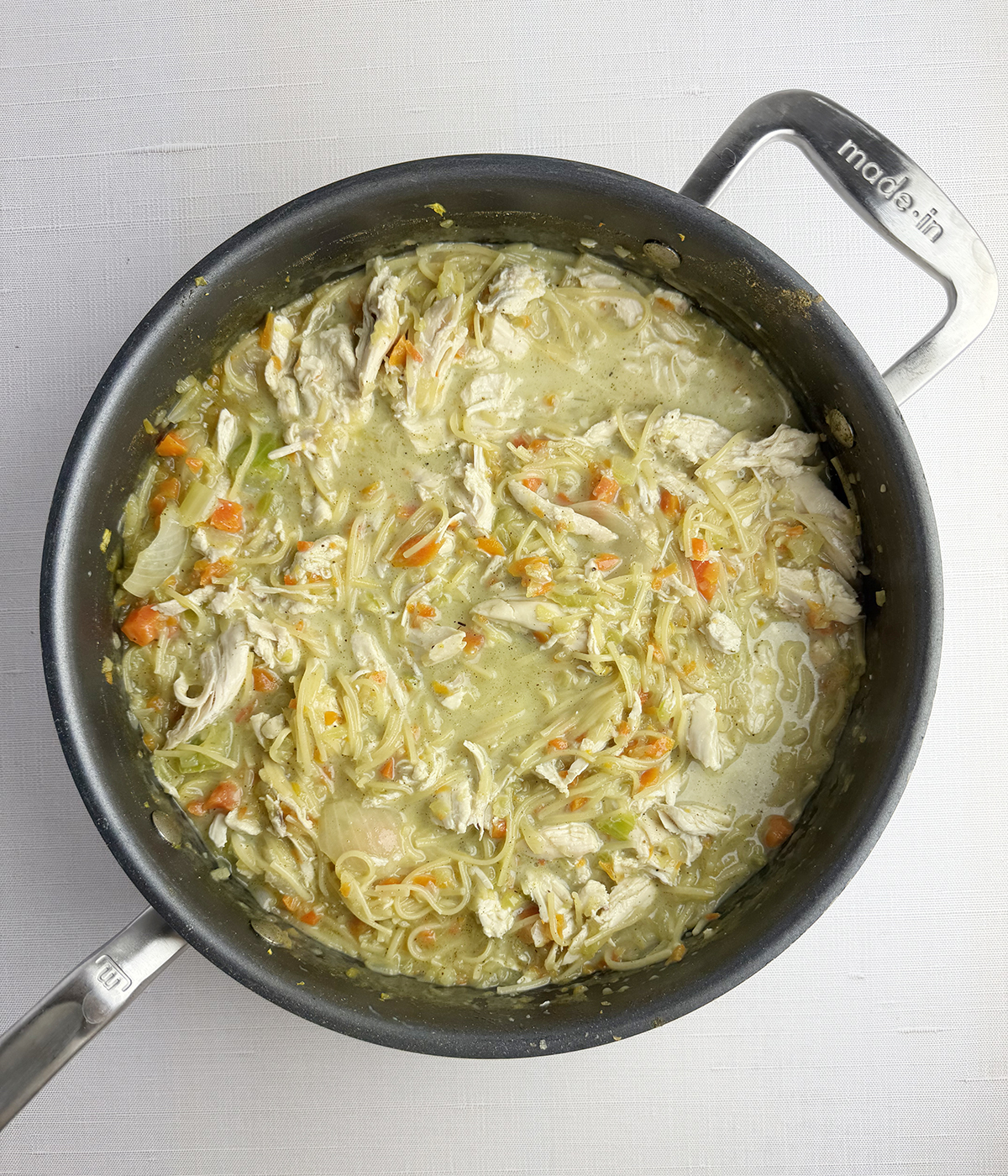 Chicken noodle casserole filling in a skillet.