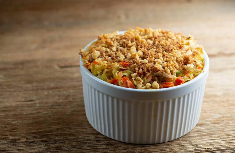 Chicken noodle casserole on a wooden counter.