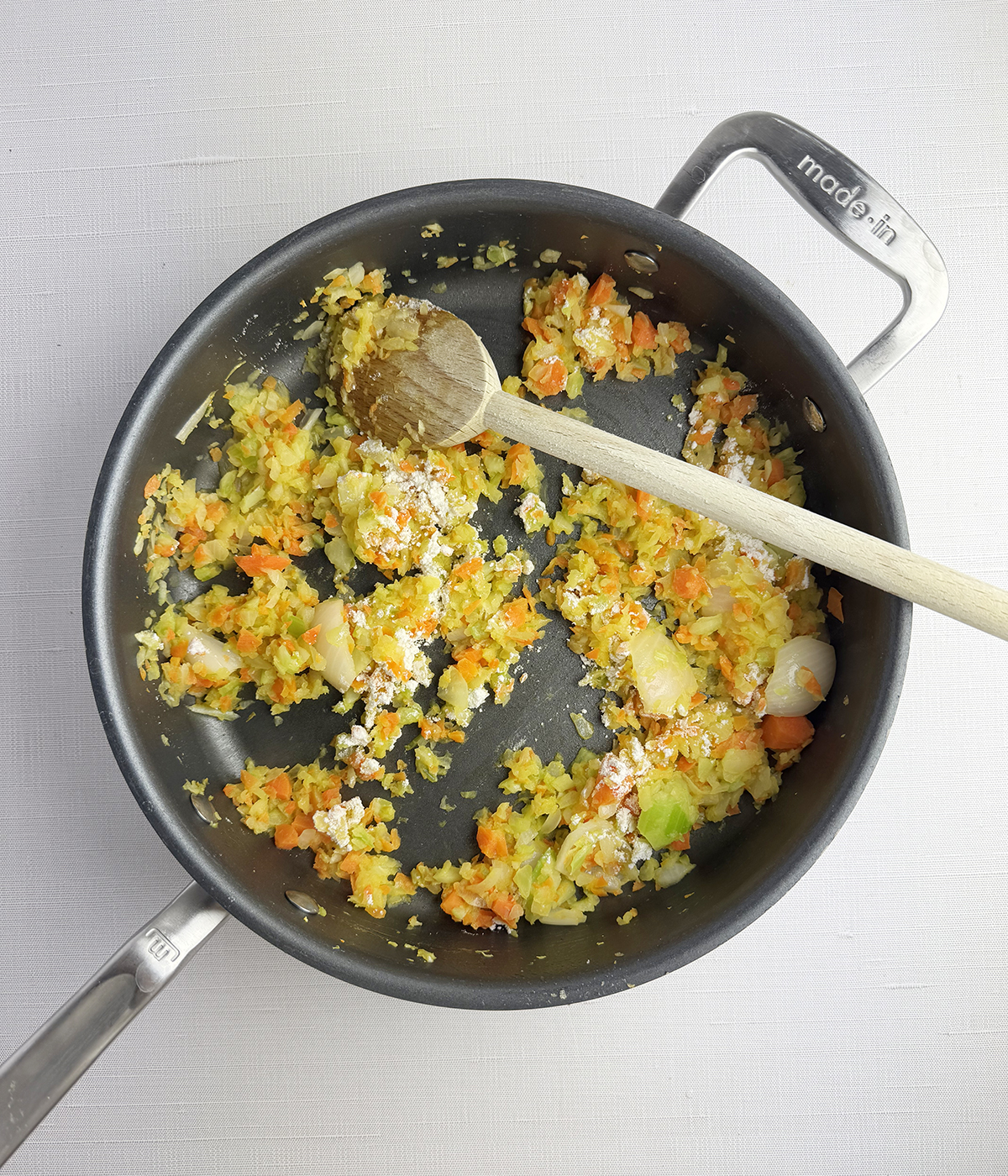 Chopped vegetables cooking in a skillet.