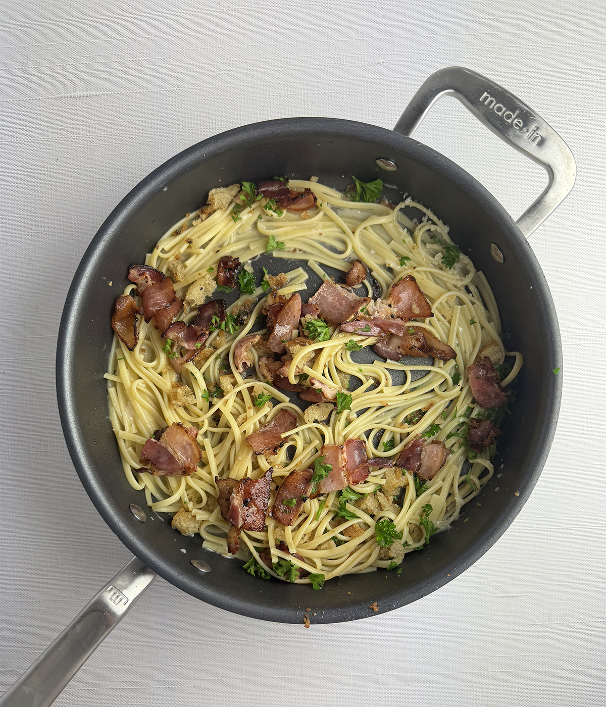 Skillet of pasta with bacon bread crumb sauce.