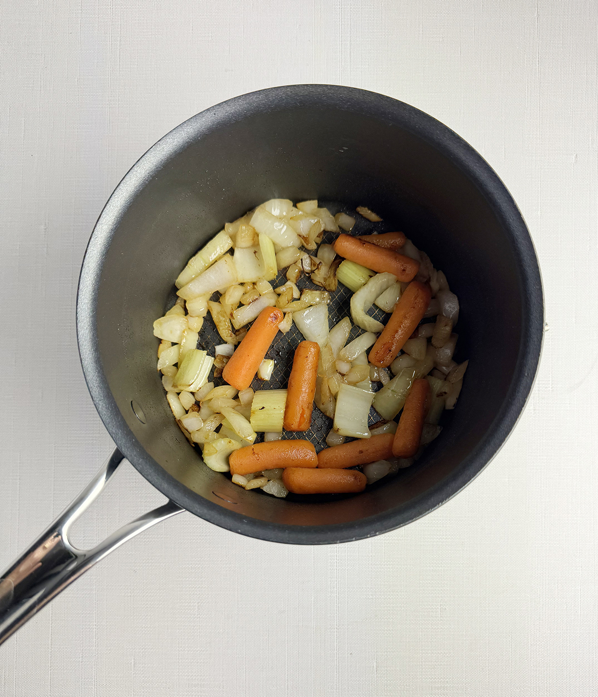 Various cooked vegetables in a pot.