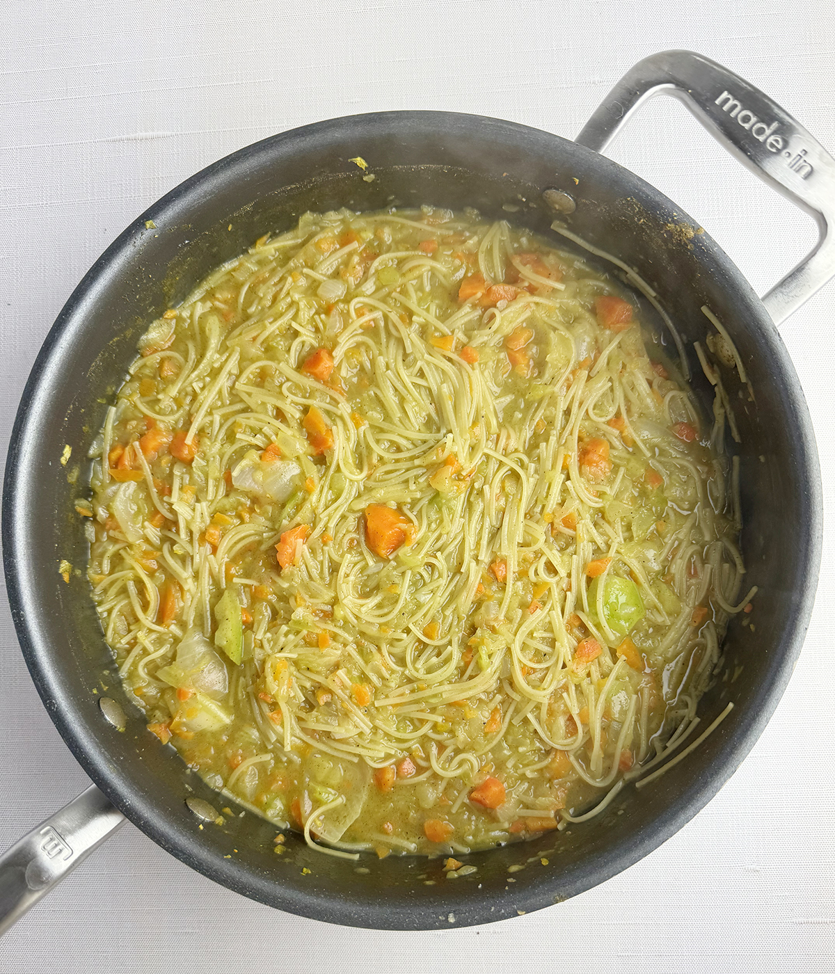 Vegetables and pasta in a skillet.
