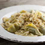 Artichoke pasta on a plate.