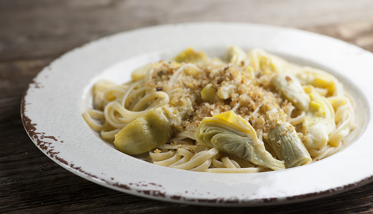 Artichoke pasta on a plate.