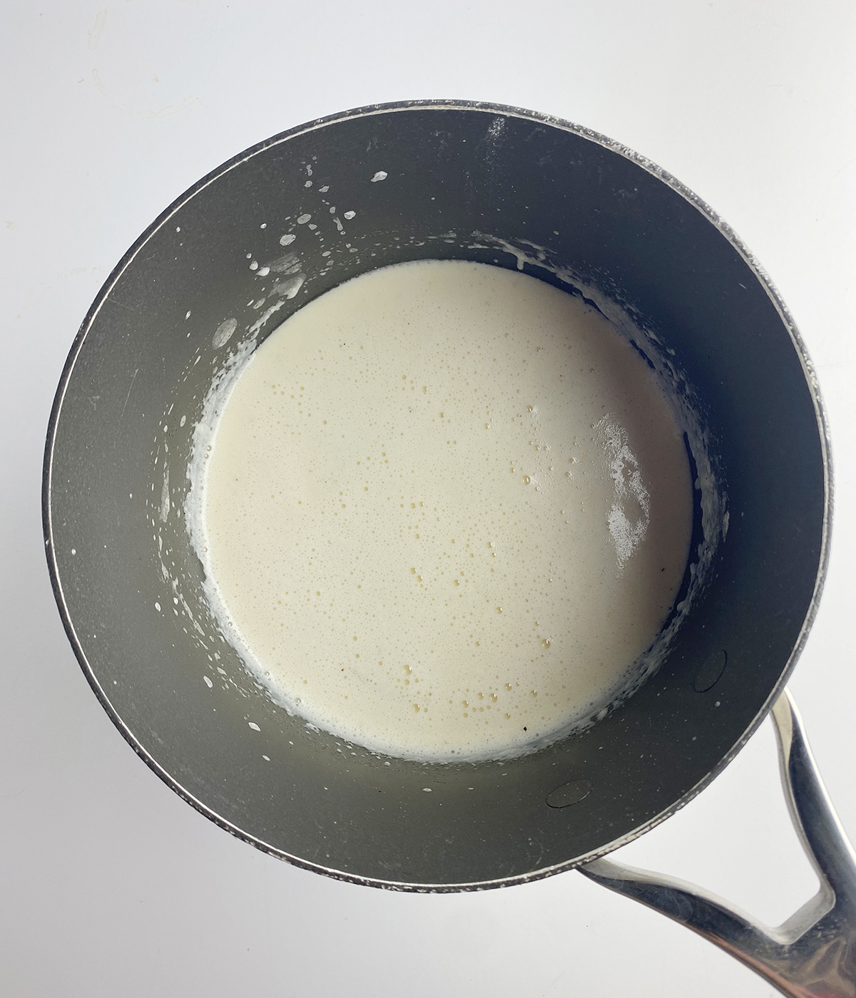 Cheddar cheese soup in a pot.
