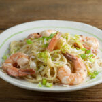 Coconut Shrimp Pasta on a white plate.