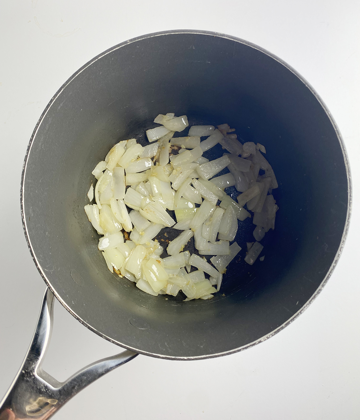 Cooked chopped onion in a pot.