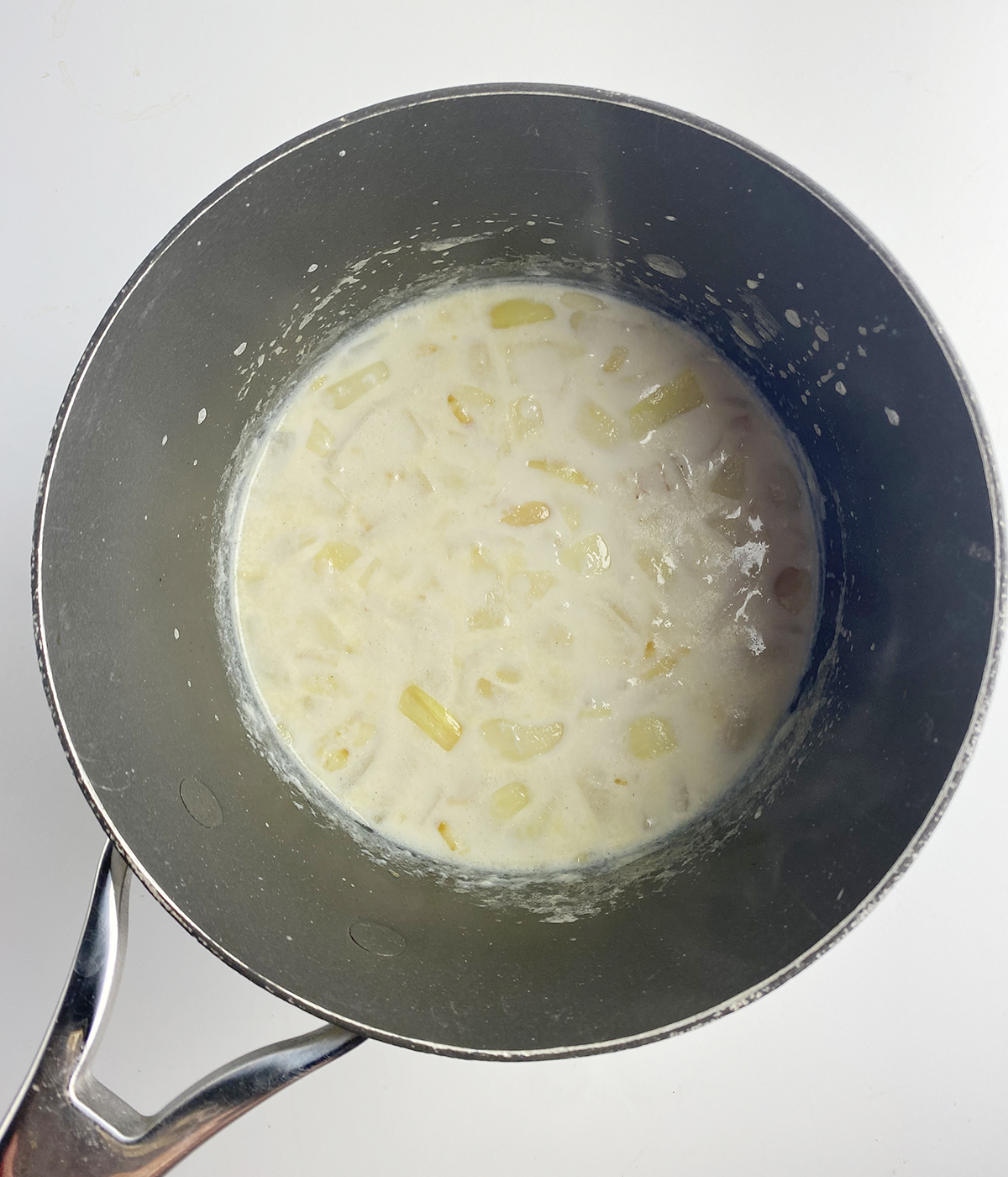 Cooked onions in a milk broth.