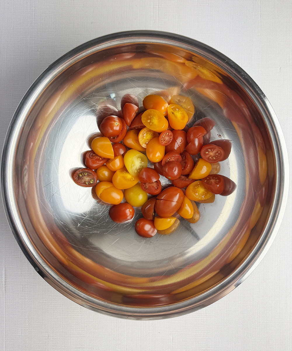 Cherry tomatoes in a metal bowl.