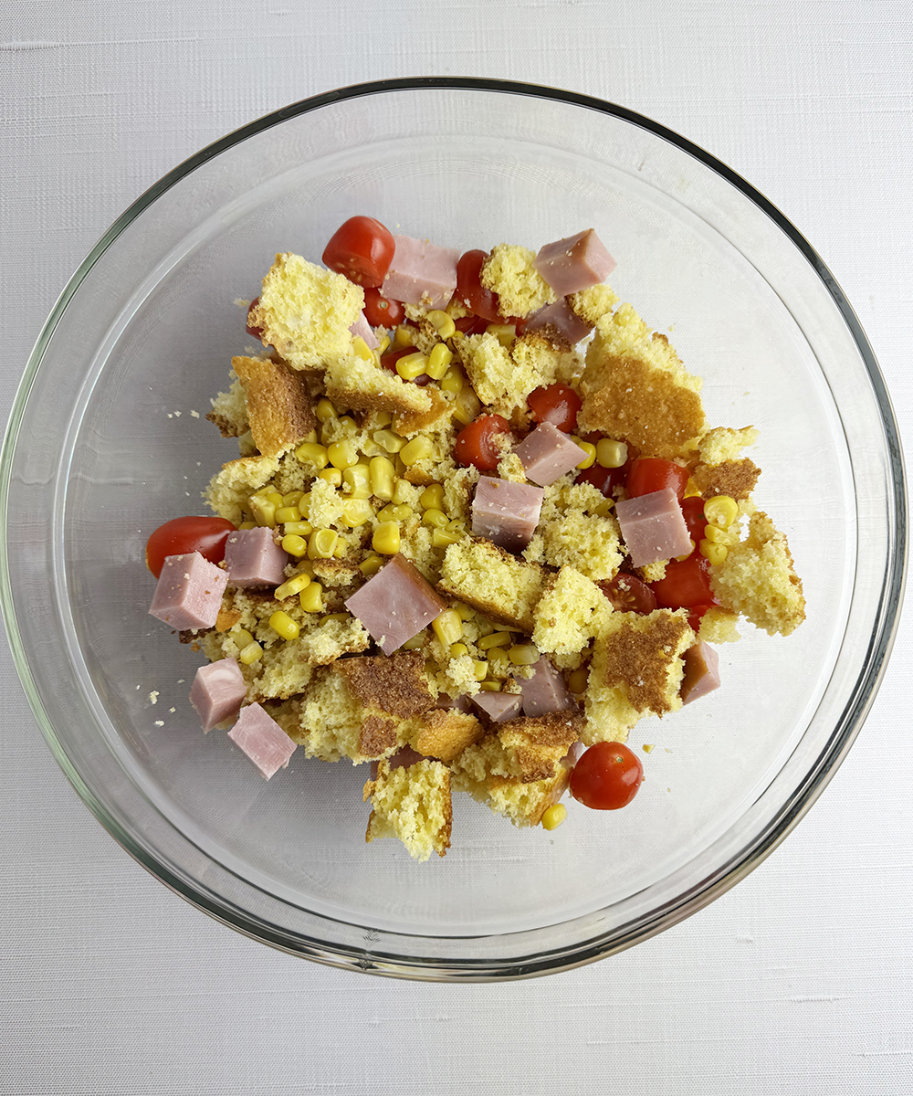 Cornbread ham and tomatoes in a bowl.
