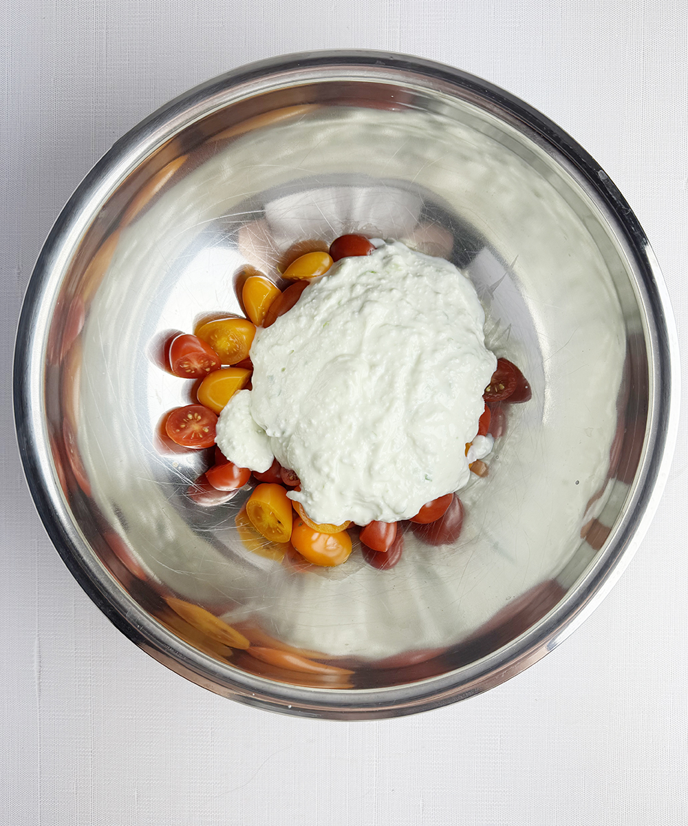 Feta cheese sauce and cherry tomatoes in a bowl.