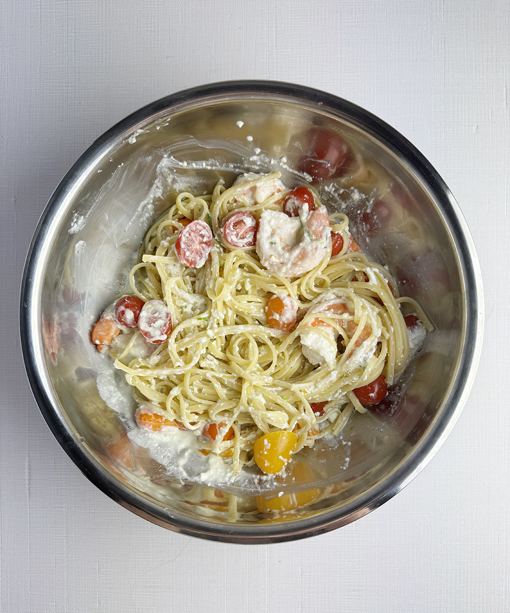 Pasta with shrimp and feta sauce in a bowl.