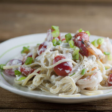 Plate of pasta with shrimp and feta cheese sauce.