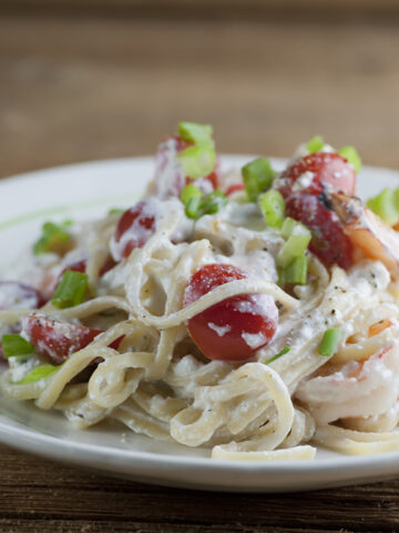 Plate of pasta with shrimp and feta cheese sauce.