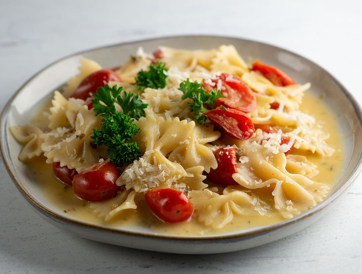 Plate of tomato parmesan pasta.