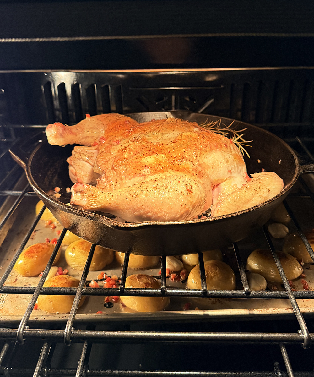 Spatchcock chicken cooking in the oven.