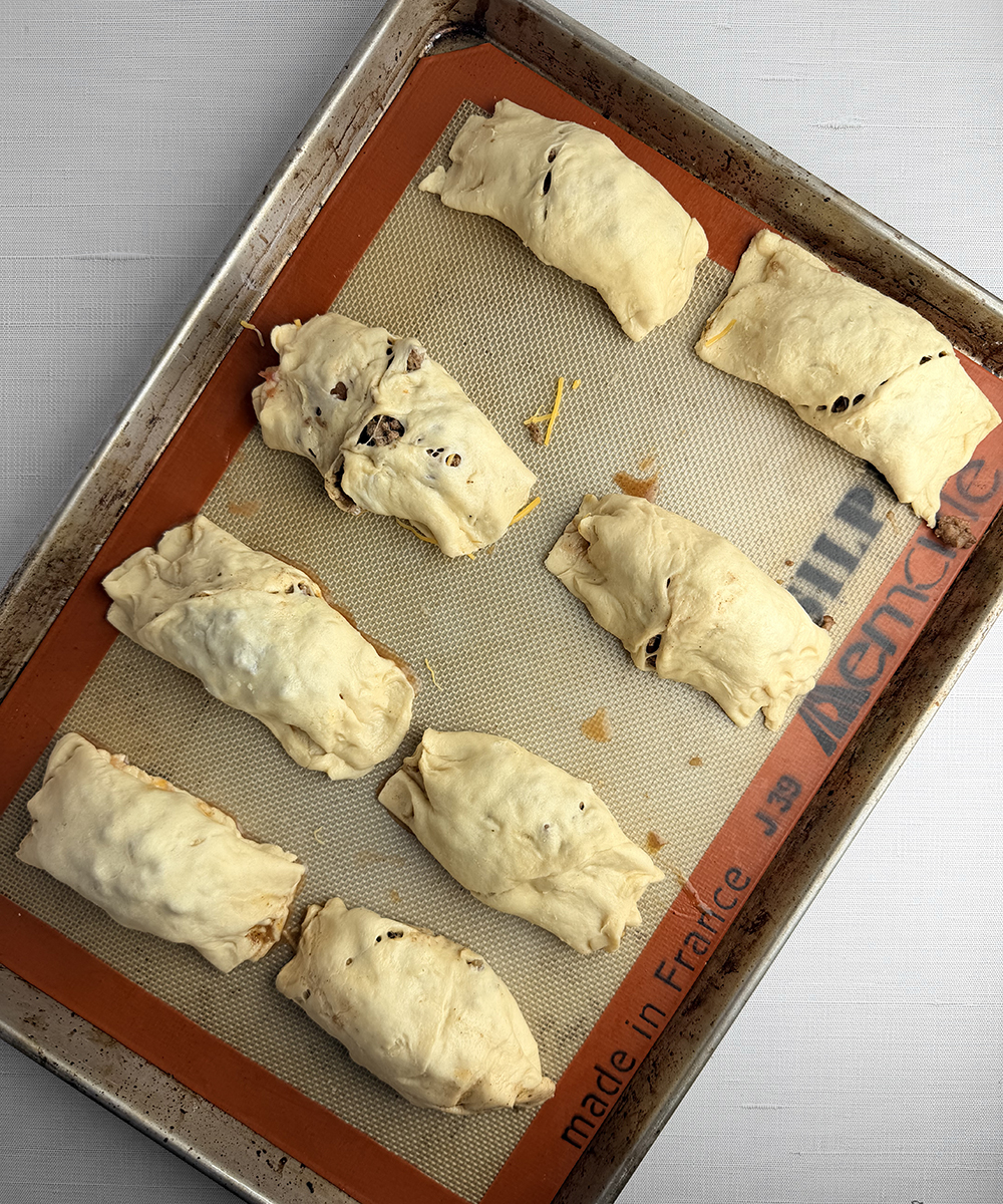 Crescent roll burritos ready for the oven.