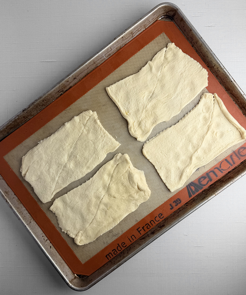 Crescent roll dough on a cookie sheet.